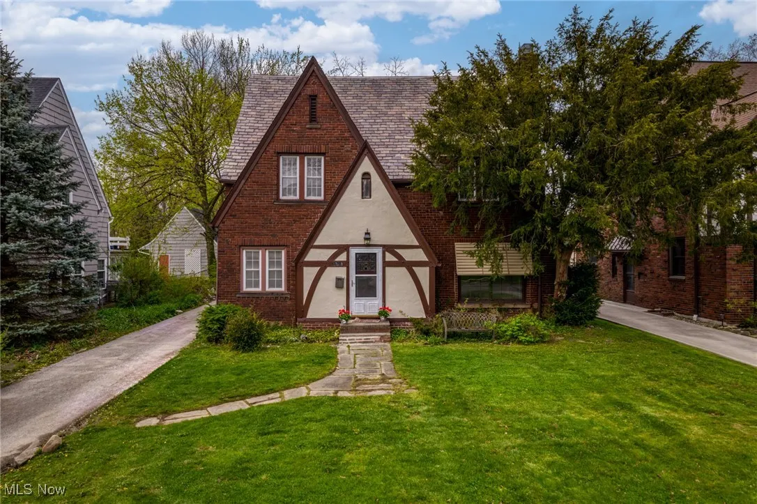 English style home with a front lawn
