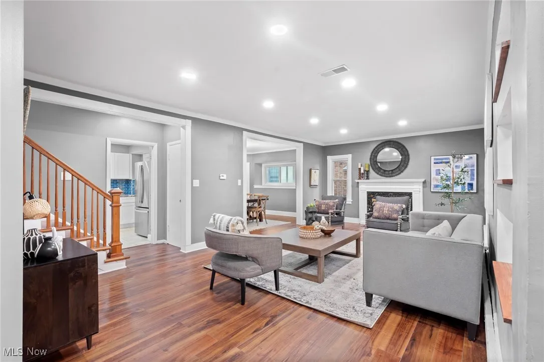 Living room featuring crown molding and wood-type flooring