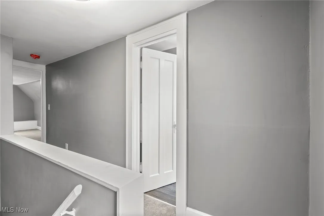 Hall featuring light colored carpet