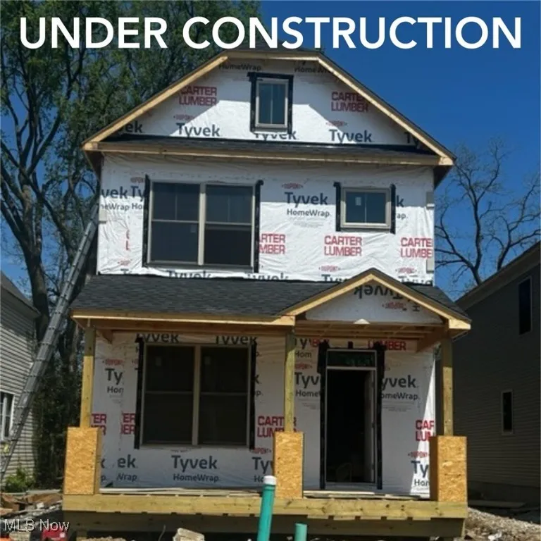 Property under construction with covered porch