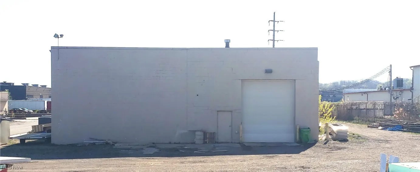 Rear view of property featuring an outdoor structure