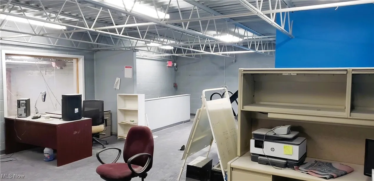 Office with unfinished concrete flooring