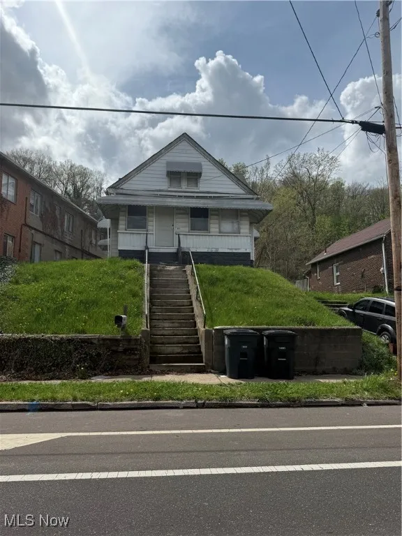 Bungalow-style home with stairs