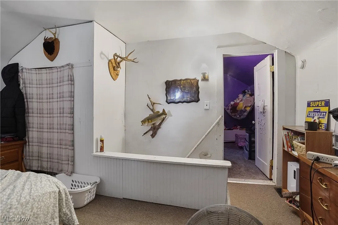 Carpeted bedroom with vaulted ceiling