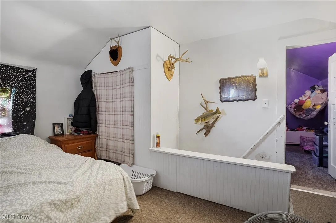 Carpeted bedroom with lofted ceiling