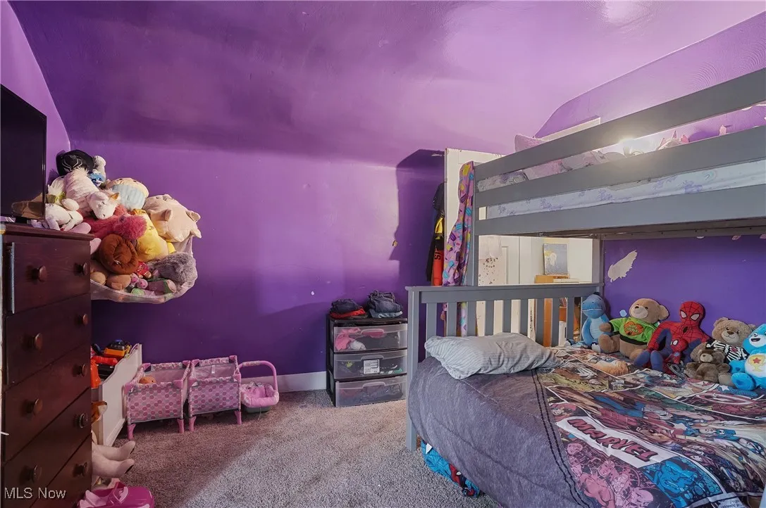 Carpeted bedroom featuring lofted ceiling