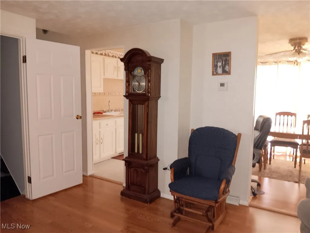 Sitting room featuring wet bar and wood finished floors