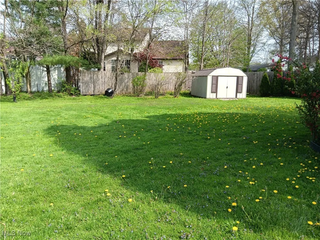 View of yard with a fenced backyard, an outdoor structure, and a shed