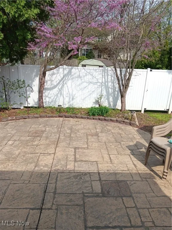 View of patio featuring fence