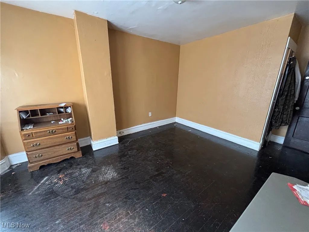 Unfurnished living room with baseboards
