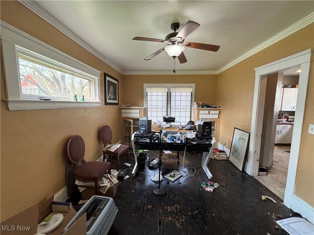 Office area featuring baseboards, ornamental molding, and ceiling fan
