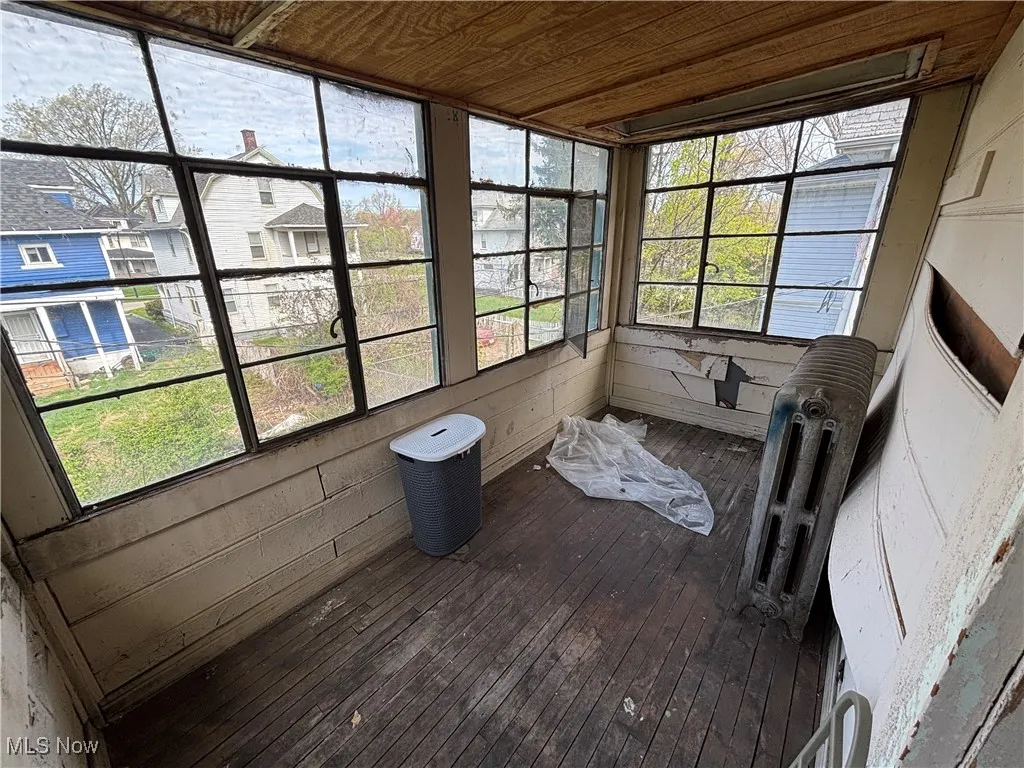 Sunroom featuring wood ceiling and hardwood / wood-style flooring