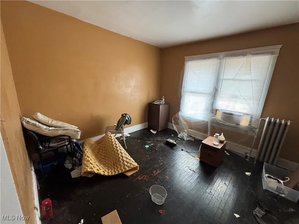 Misc room with baseboards and hardwood / wood-style floors