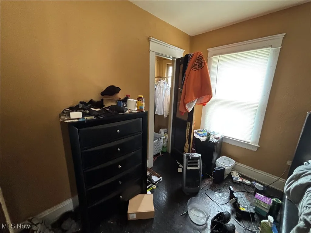 Bedroom with baseboards and wood finished floors