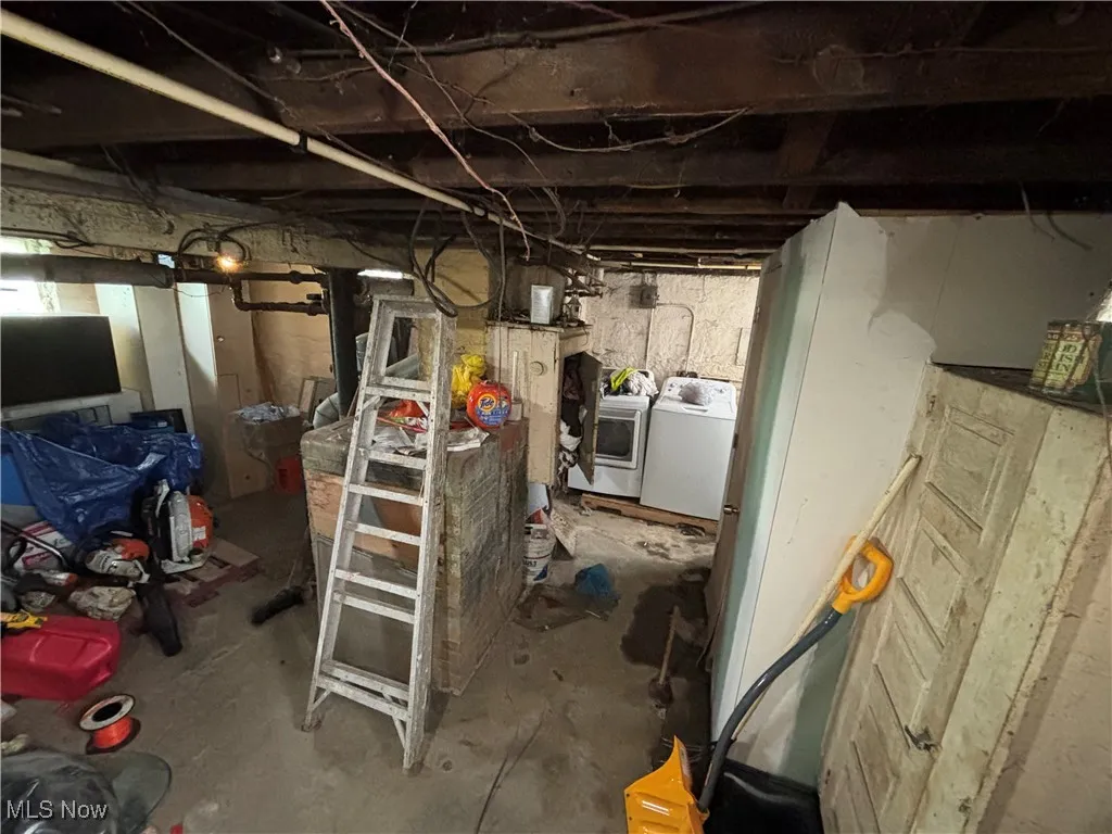 Unfinished below grade area with independent washer and dryer