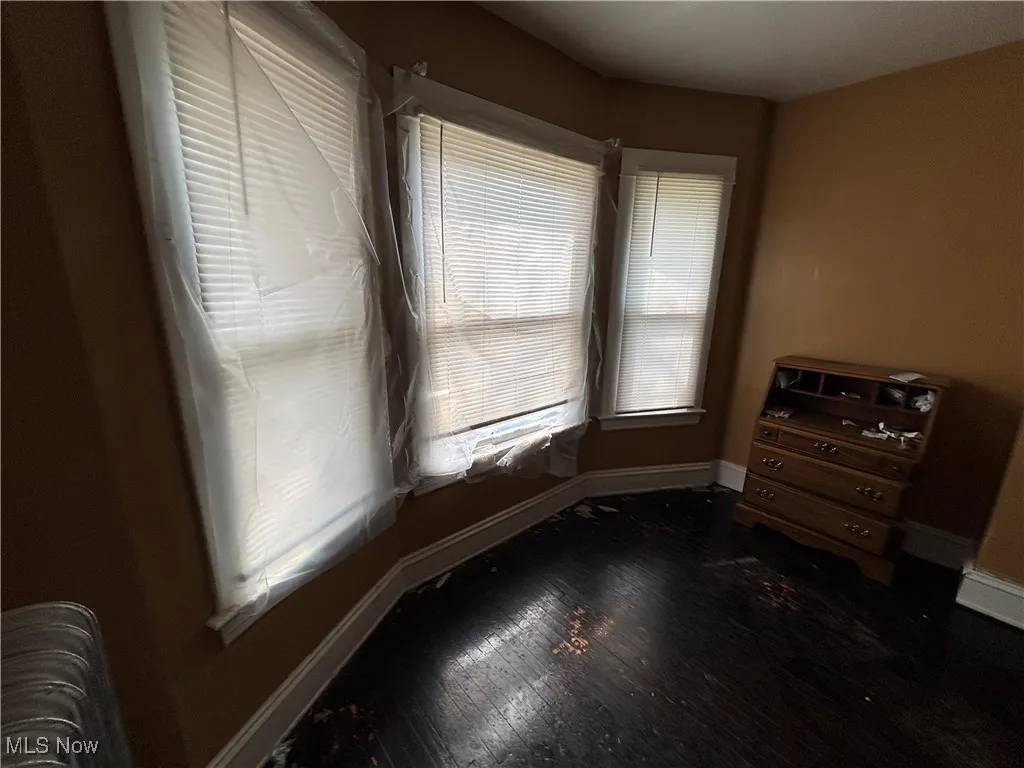 Empty room featuring baseboards and wood finished floors