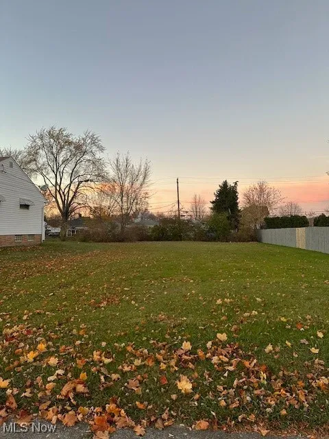View of yard featuring fence