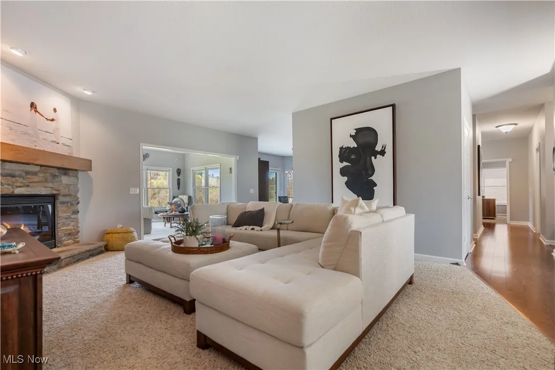 Living room featuring baseboards, wood finished floors, and a fireplace