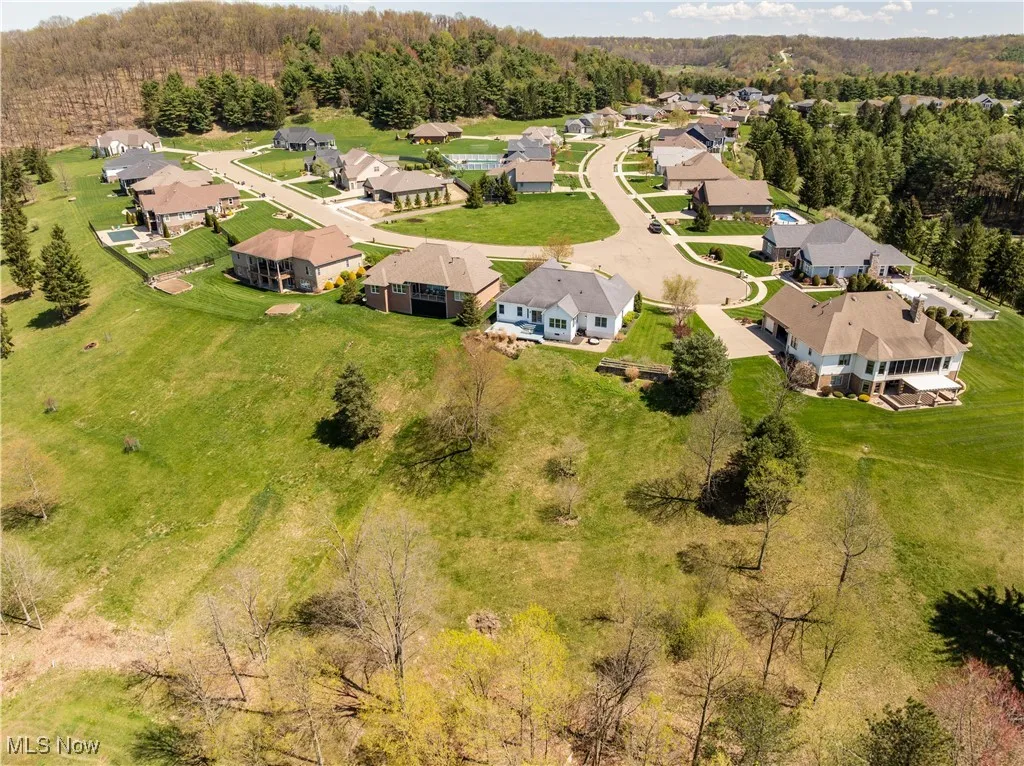 Aerial view featuring a view of trees and a residential view