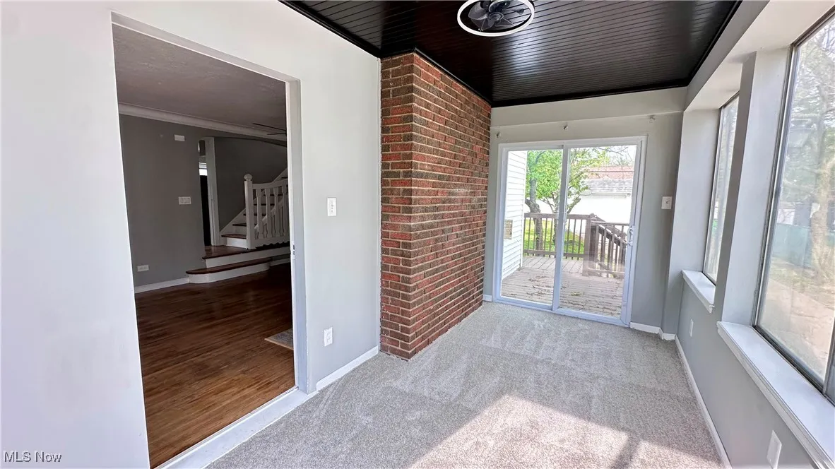 Doorway to outside with stairway, baseboards, and wood finished floors