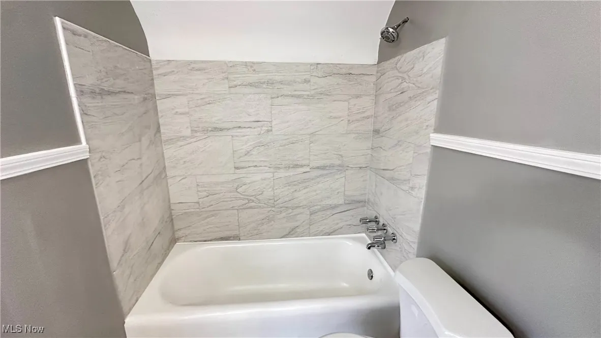 Full bathroom with toilet and shower / tub combination