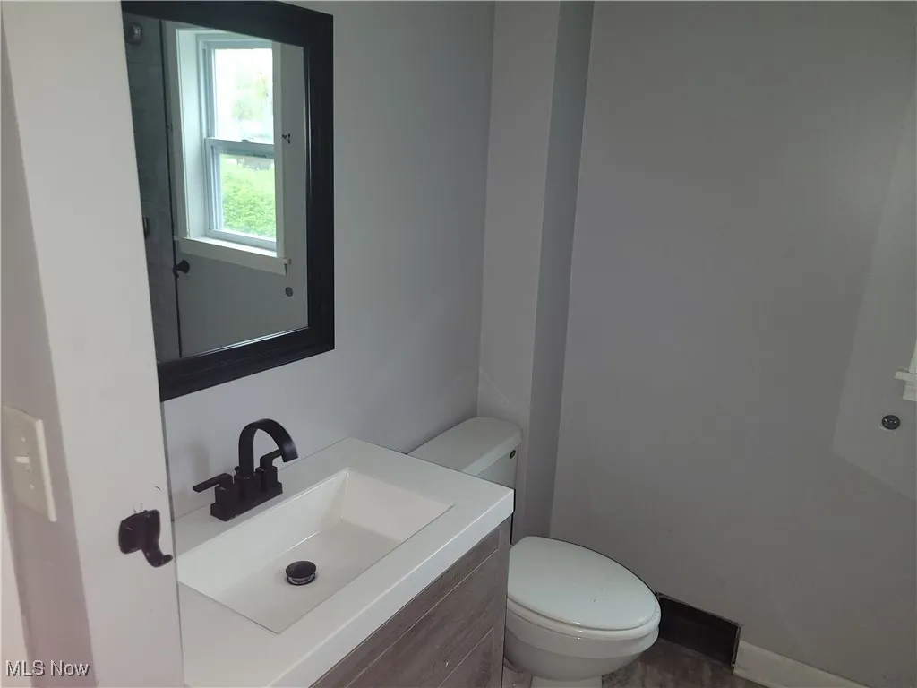 Half bath featuring vanity and toilet