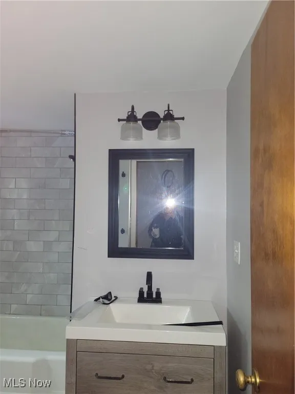 Bathroom featuring vanity and bathing tub / shower combination