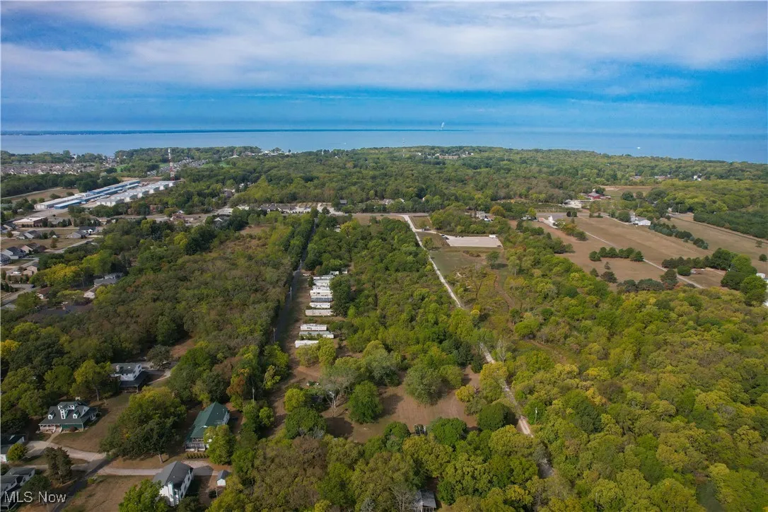 Birds eye view of property featuring a wooded view