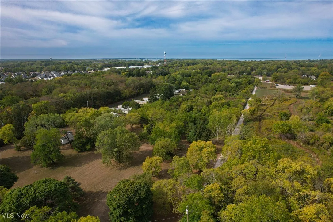 Birds eye view of property with a view of trees