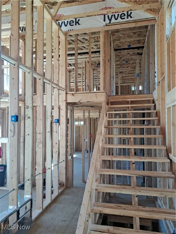 Staircase with plenty of natural light and a towering ceiling