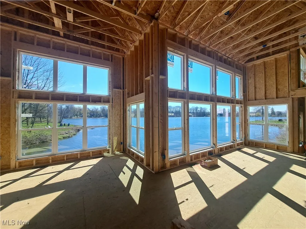 Unfurnished sunroom featuring plenty of natural light and a water view