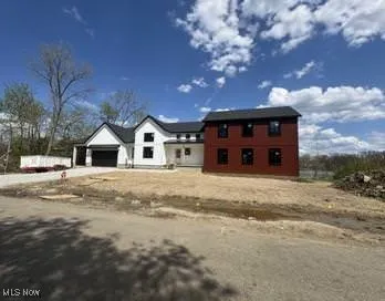 View of front of home featuring an attached garage and concrete driveway