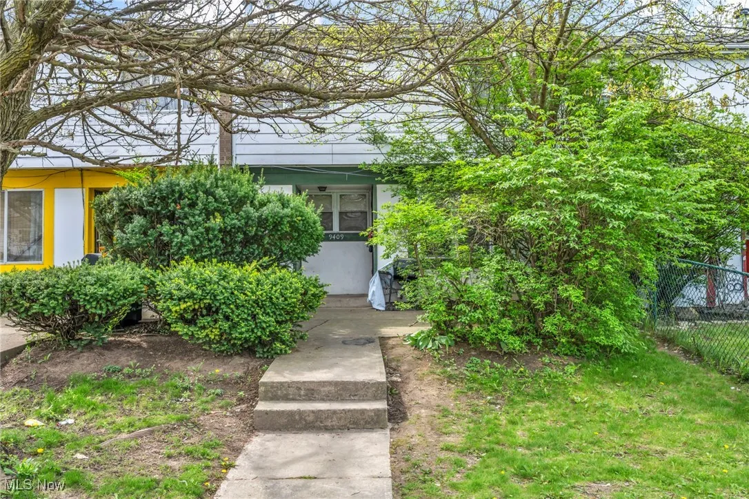View of exterior entry featuring fence and stucco siding