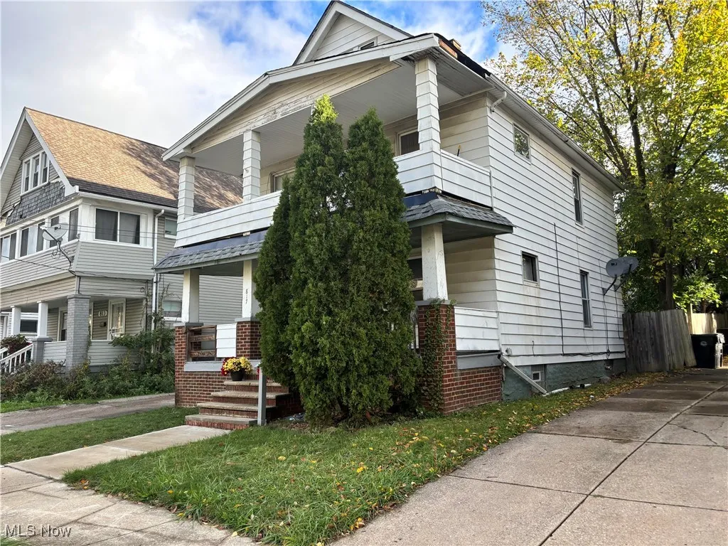 View of front of property with a porch and a balcony