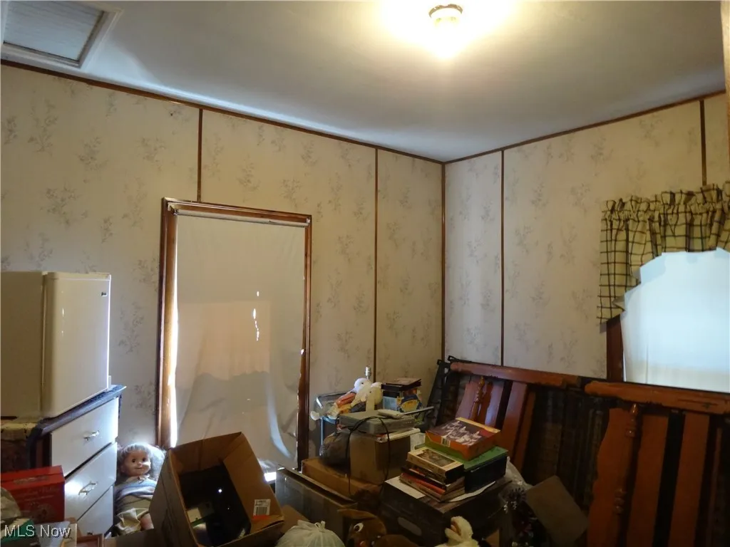 Bedroom featuring paneling on walls