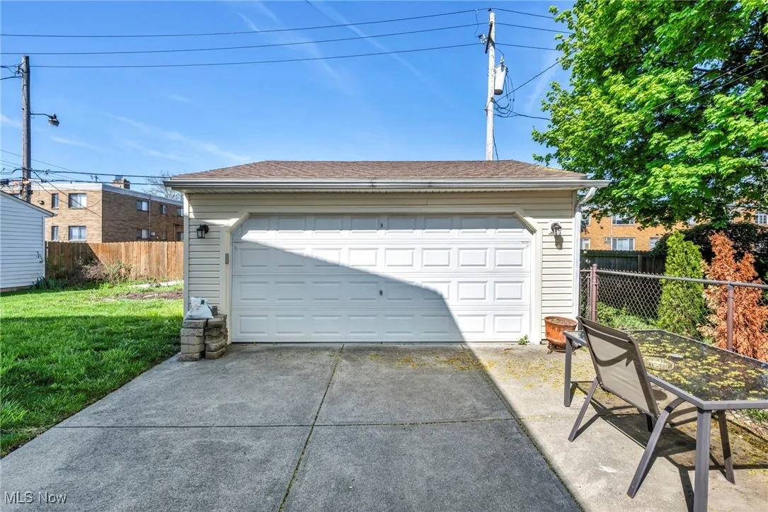 Detached garage featuring fence