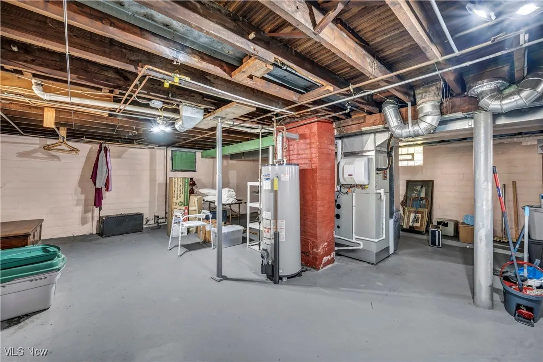 Basement featuring heating unit and gas water heater