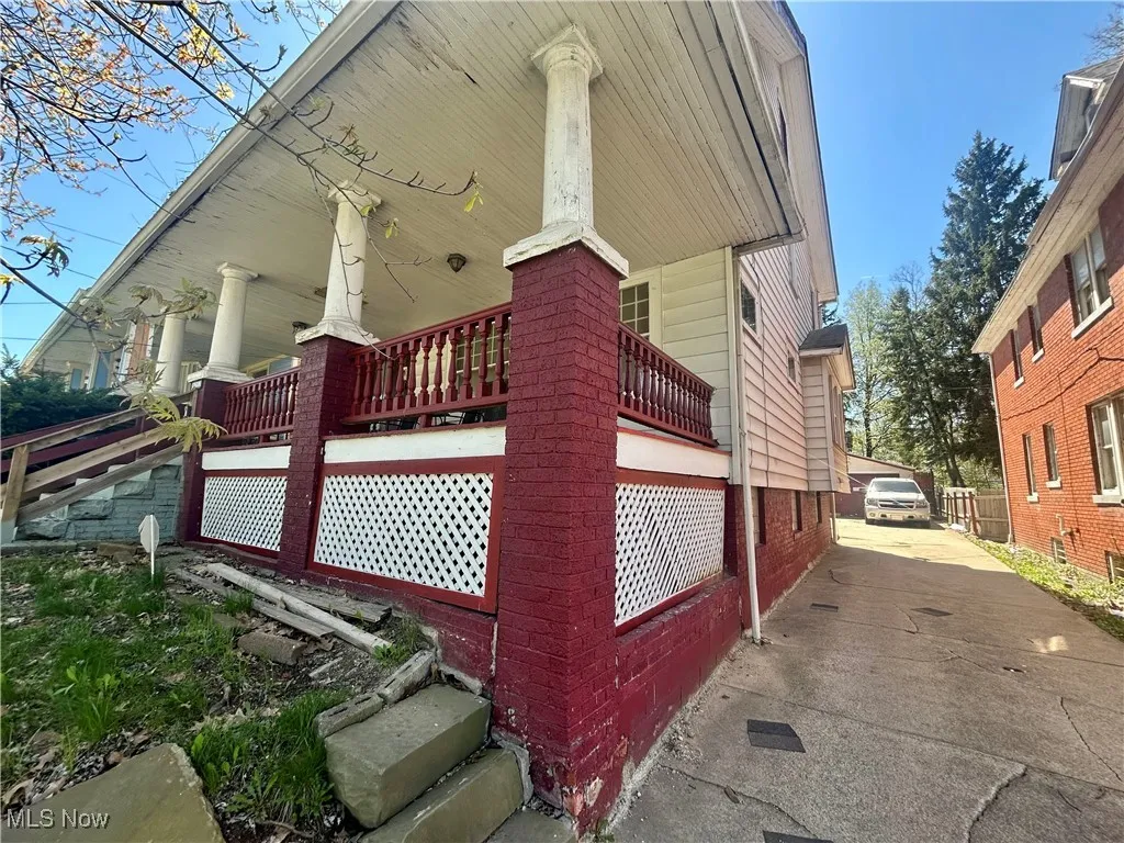 View of home's exterior with brick siding and fence