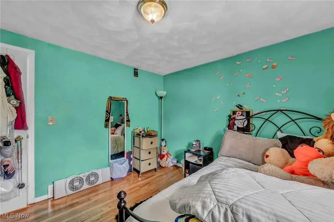 Bedroom featuring baseboards and wood finished floors