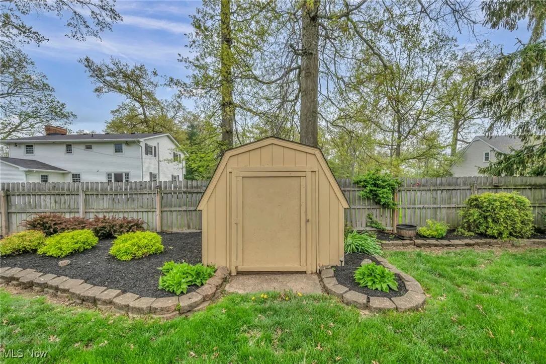 View of shed with a fenced backyard