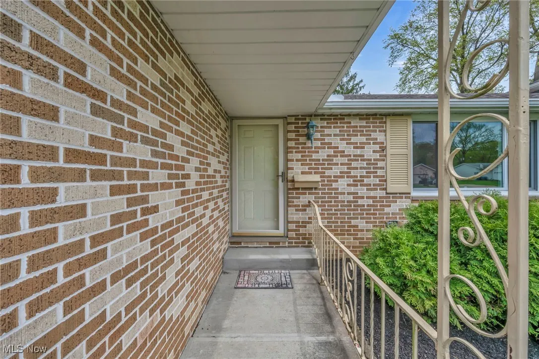 Doorway to property with brick siding