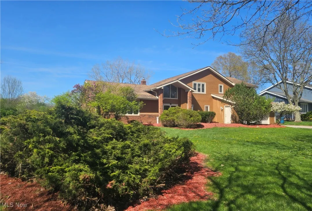 View of front of home with a chimney and a front lawn