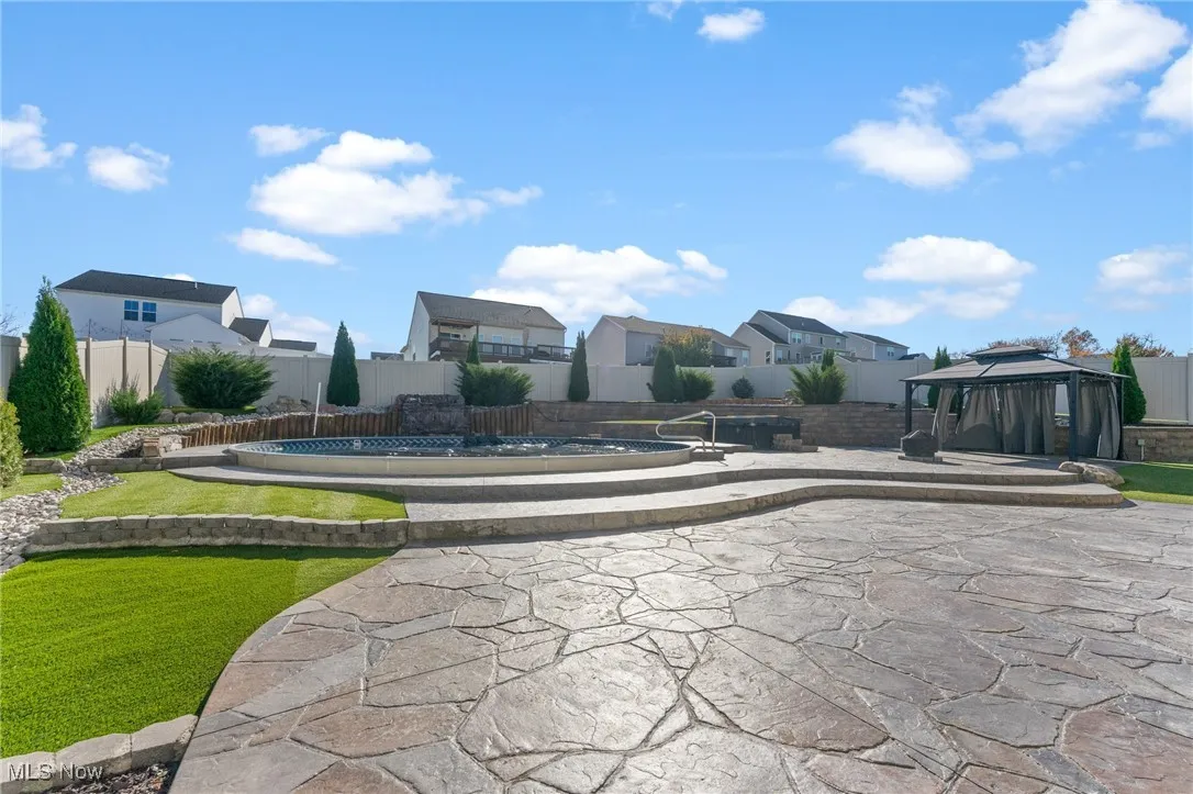 View of home's community featuring a residential view, a patio, a gazebo, a fenced backyard, and a swimming pool
