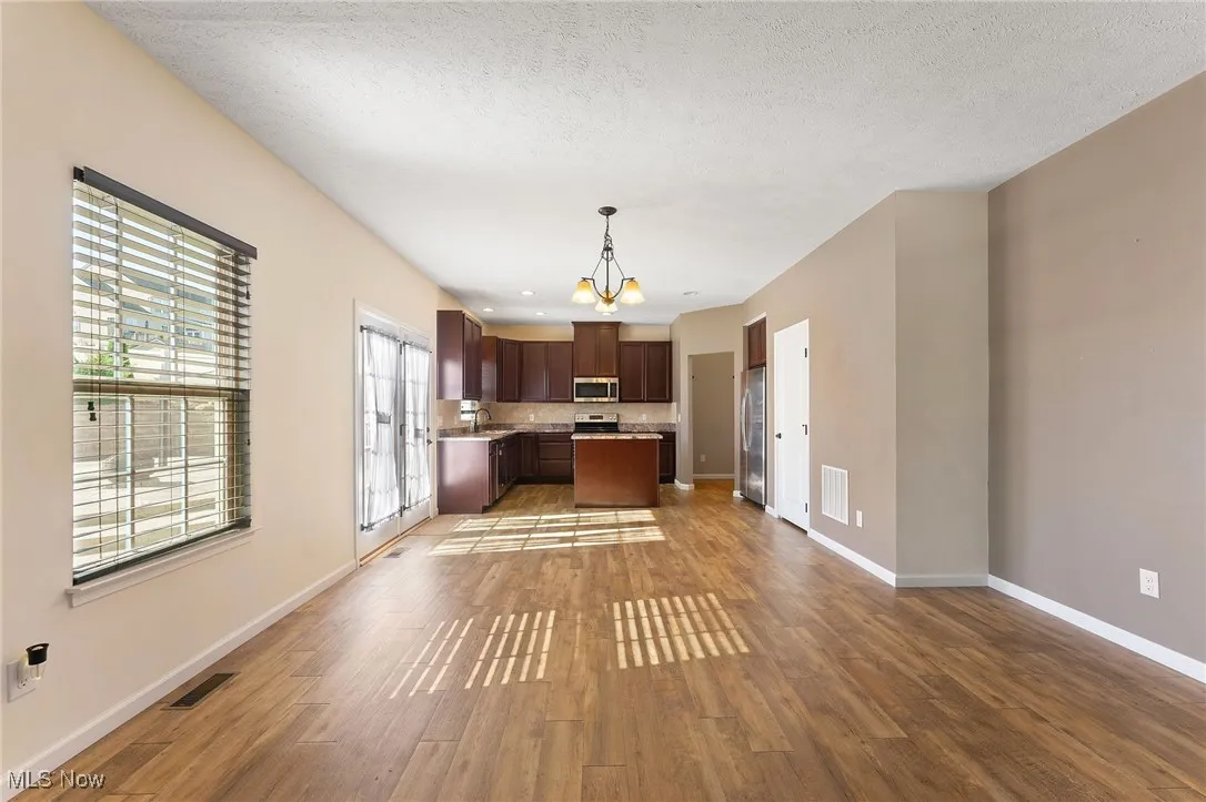 Kitchen featuring visible vents, light countertops, baseboards, and appliances with stainless steel finishes