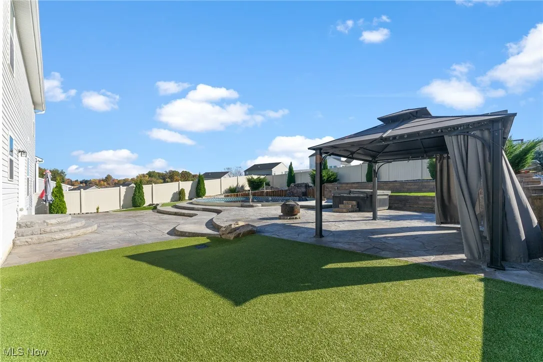 View of yard featuring a gazebo, a fenced backyard, and a patio