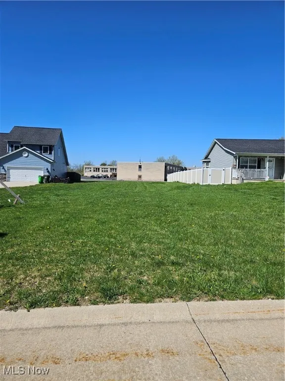 View of yard featuring fence