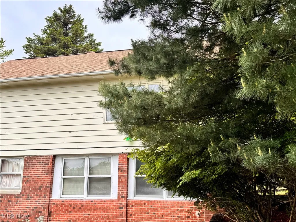 View of side of home with brick siding