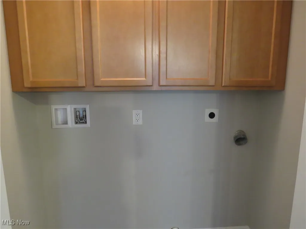 Laundry area featuring cabinet space, electric dryer hookup, and washer hookup