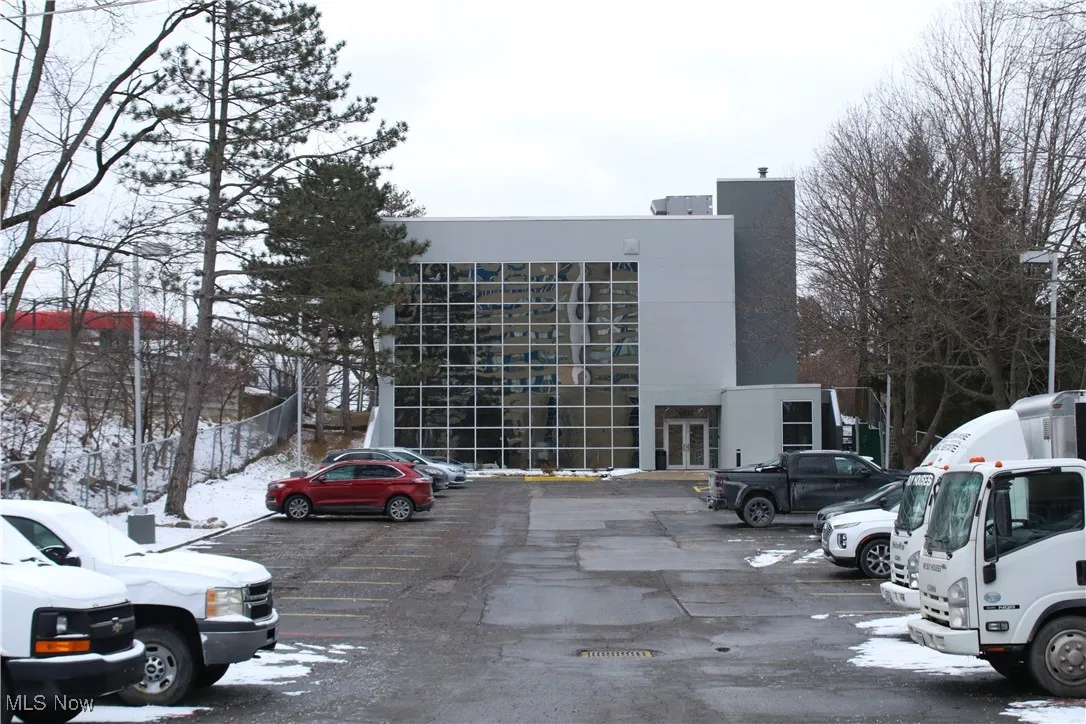 Snow covered building featuring uncovered parking