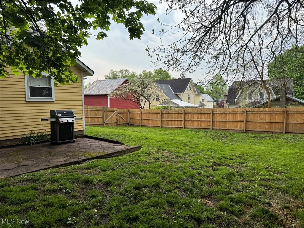 View of yard featuring a fenced backyard and a patio area